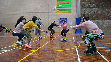 People rollerskating doing a squat